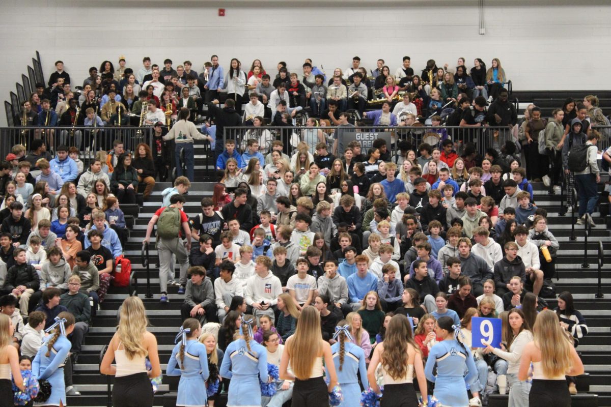 Students sit in the bleachers, waiting for the winter pep rally to begin. The cheerleaders and dance team hyped everyone up as they walked in.