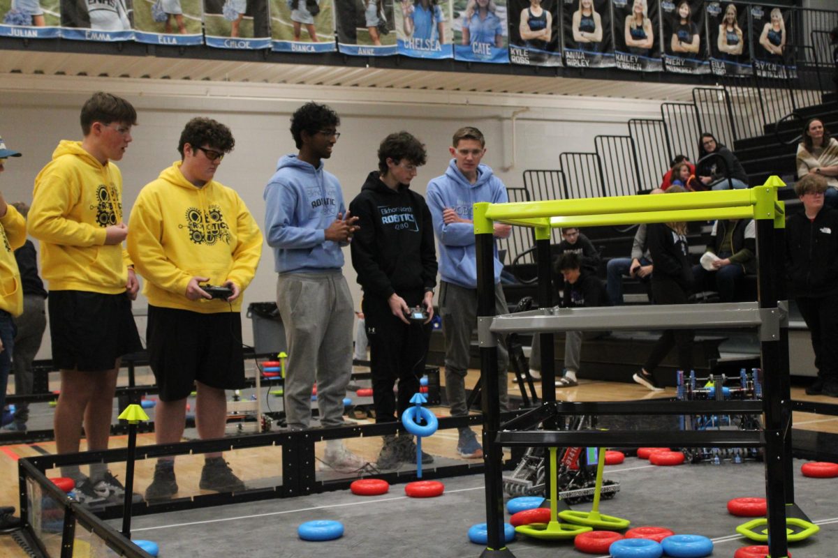 Senior Robotics pilot Zane Larson controls the teams robot at a home robotics tournament. Larson and his team had to get colored rings onto poles around the playing area to gain points and beat their competition..