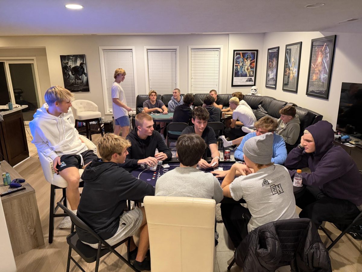 Group of senior boys sitting around two tables playing poker with each other hoping to end the night positive. Almost every week the group plays poker with each other, either in big or smaller groups. 

Photo courtesy of Renee Vokt