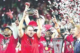 Indiana head coach Curt Cignetti holds up the championship trophy after the Big Ten championship NCAA college football game against Ohio State in Indianapolis, Saturday, Dec. 6, 2025.