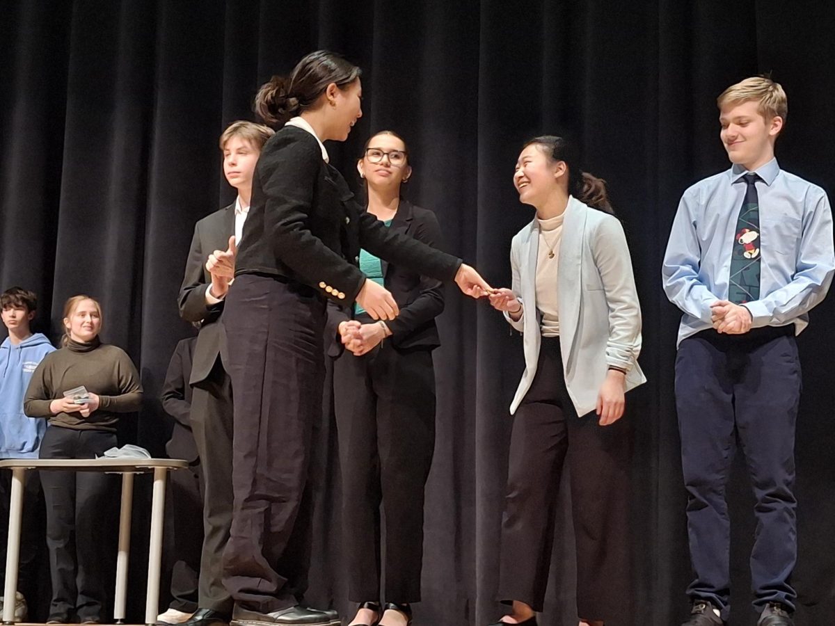 Sophomore Ellie Duan accepts a medal for Entertainment Speaking. Performers in the entertainment must have a visual aid and comedic aspects to their speech.