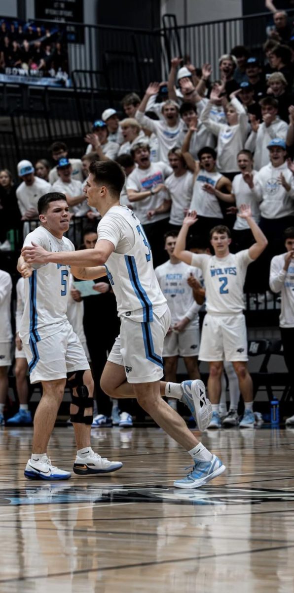 Seniors Sutton Piatkowski and Ethan Beachy high five at mid court in a game vs McCook on monday, March 2. The wolves won the game 72-45.