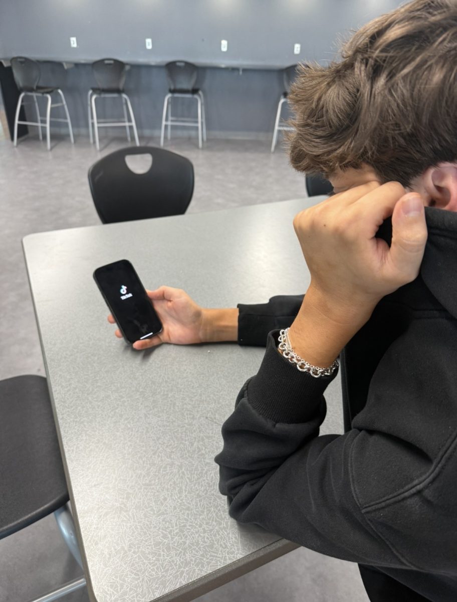 Junior Simon Murphy opens up TikTok on his phone. 